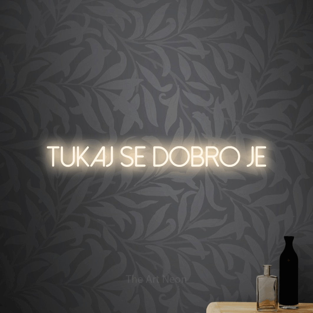 LED neon sign reading “Tukaj se Dobro je”, arranged in a single line.