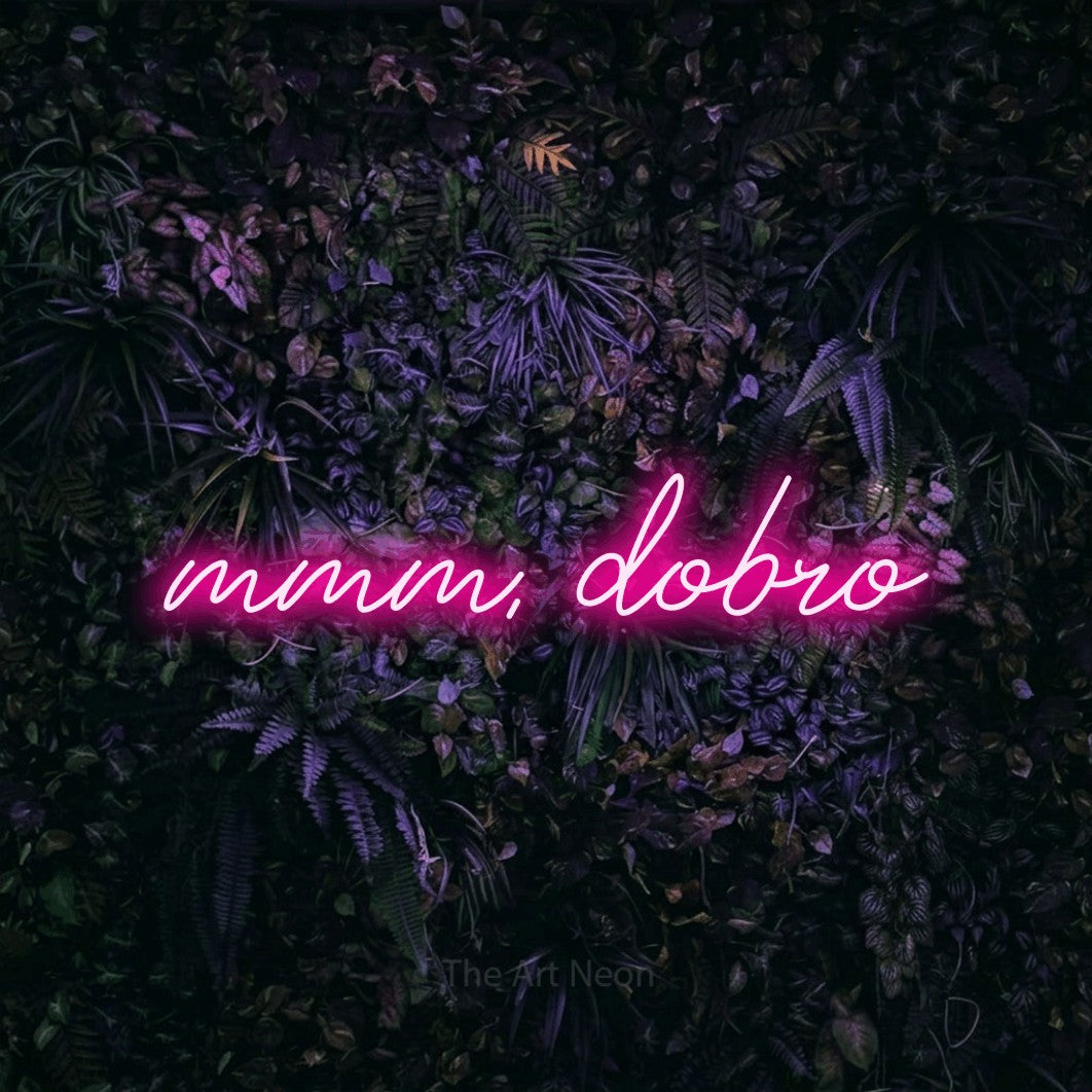 LED neon sign reading “mmm, dobro”, arranged in a single line.