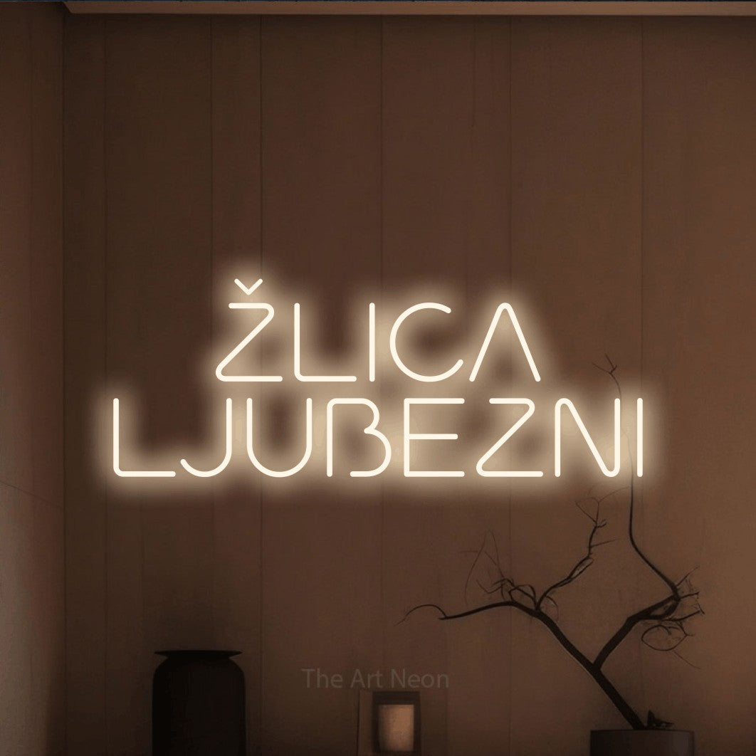 LED neon sign reading “ŽLICA LJUBEZNI”, arranged in two lines.