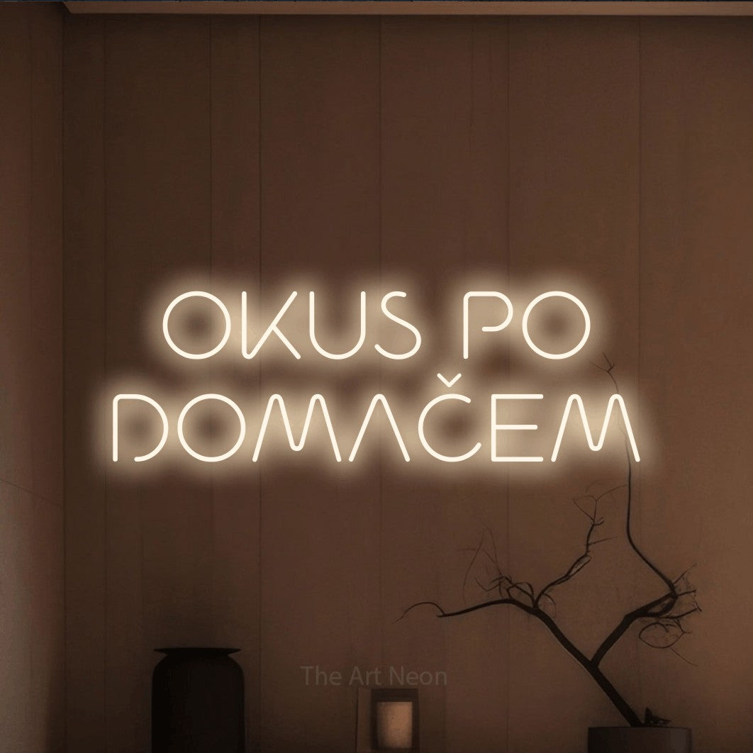 LED neon sign reading “OKUS PO DOMAČEM”, arranged in two lines.