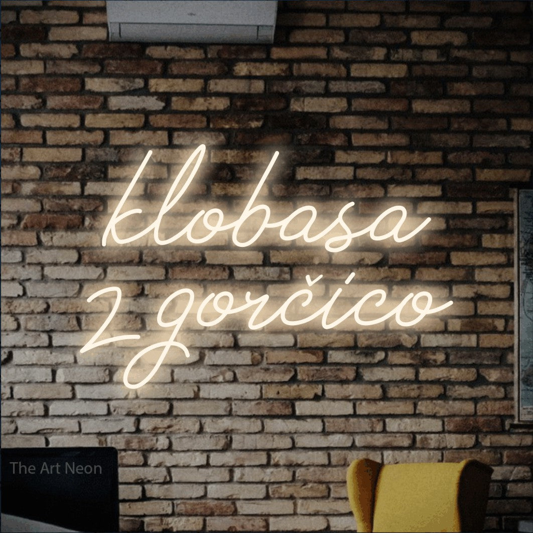 LED neon sign reading “klobasa z gorčico”, arranged in two lines.