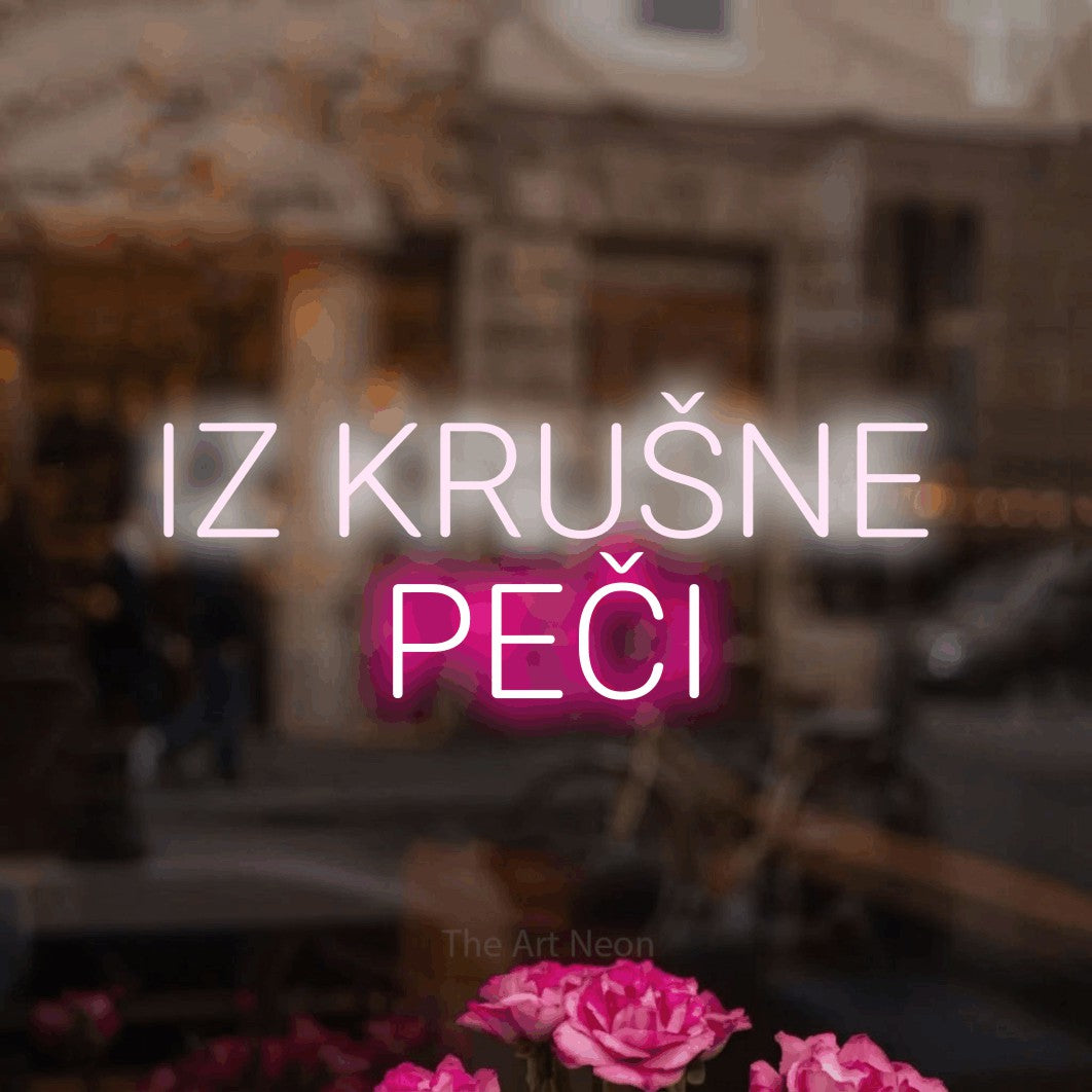 LED neon sign reading “IZ KRUŠNE PEČI”, arranged in two lines.