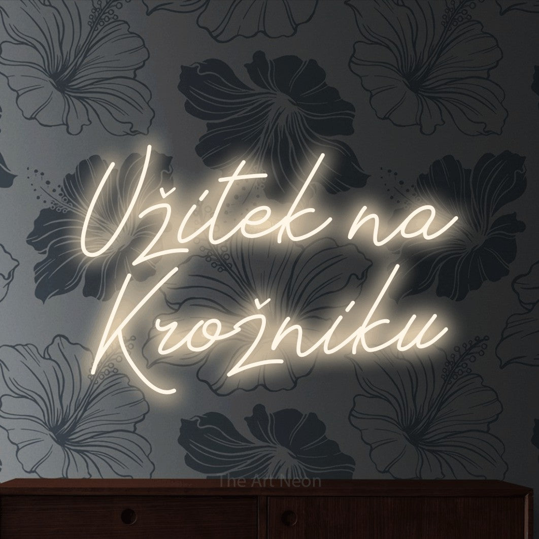 LED neon sign reading “Užitek na Krožniku”, arranged in two lines.