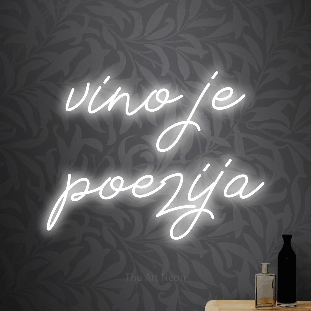 LED neon sign reading “vino je poezija”, arranged in two lines.