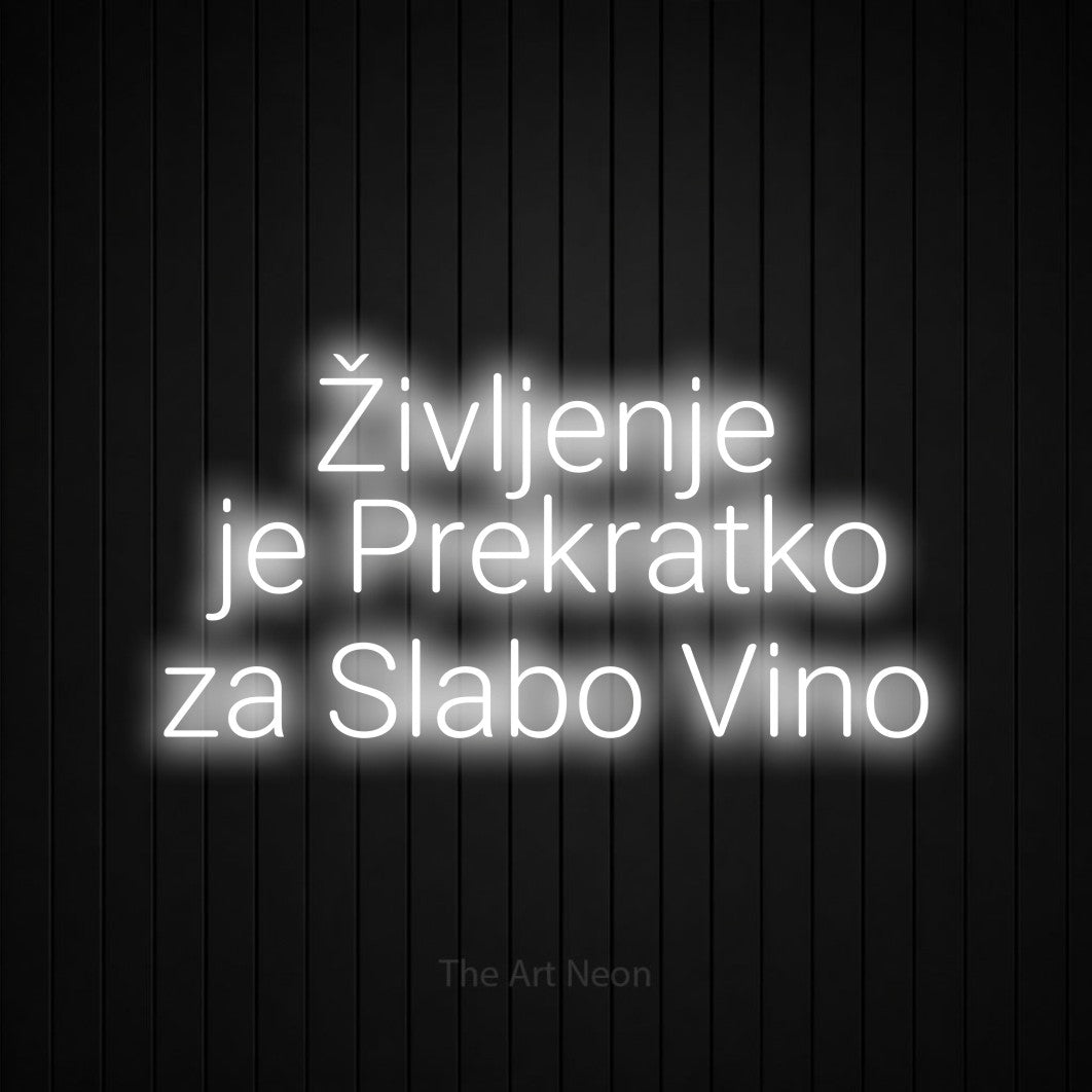 LED neon sign reading “Življenje je Prekratko za Slabo Vino”, arranged in three lines.
