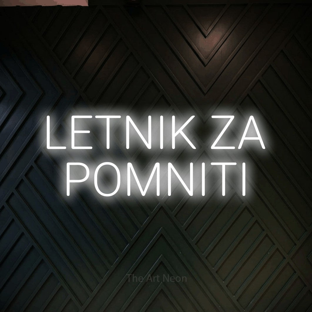 LED neon sign reading “LETNIK ZA POMNITI”, arranged in two lines.