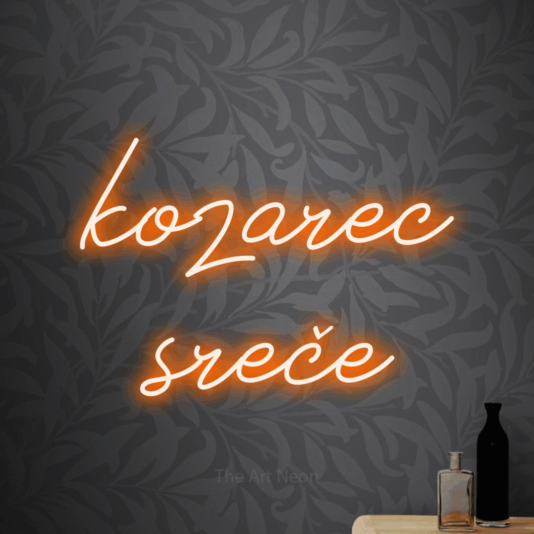 LED neon sign reading “kozarec sreče”, arranged in two lines.