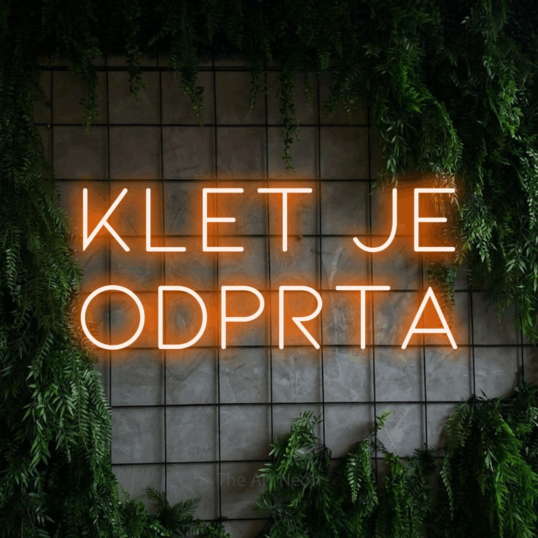 LED neon sign reading “Klet je Odprta”, arranged in two lines.