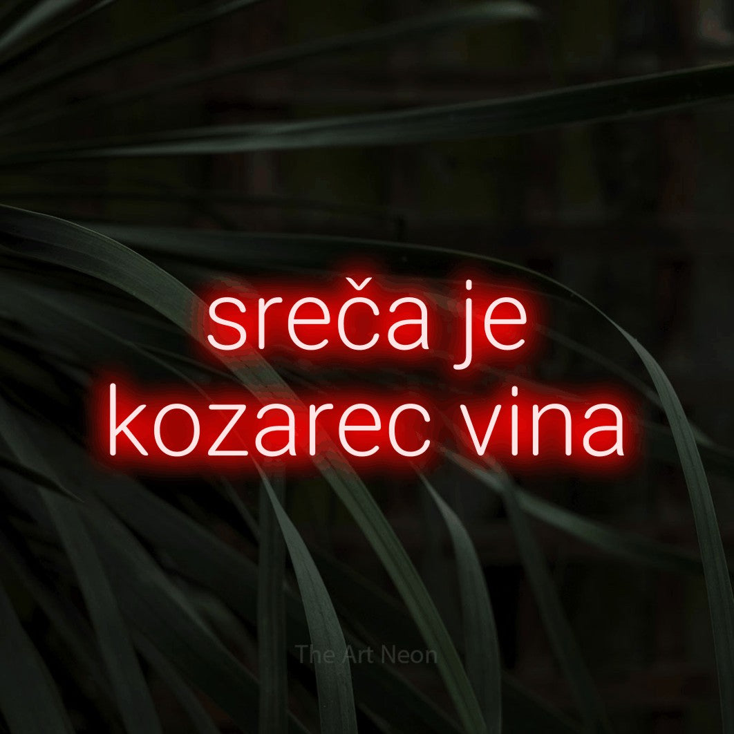 LED neon sign reading “sreča je kozarec vina”, arranged in two lines.
