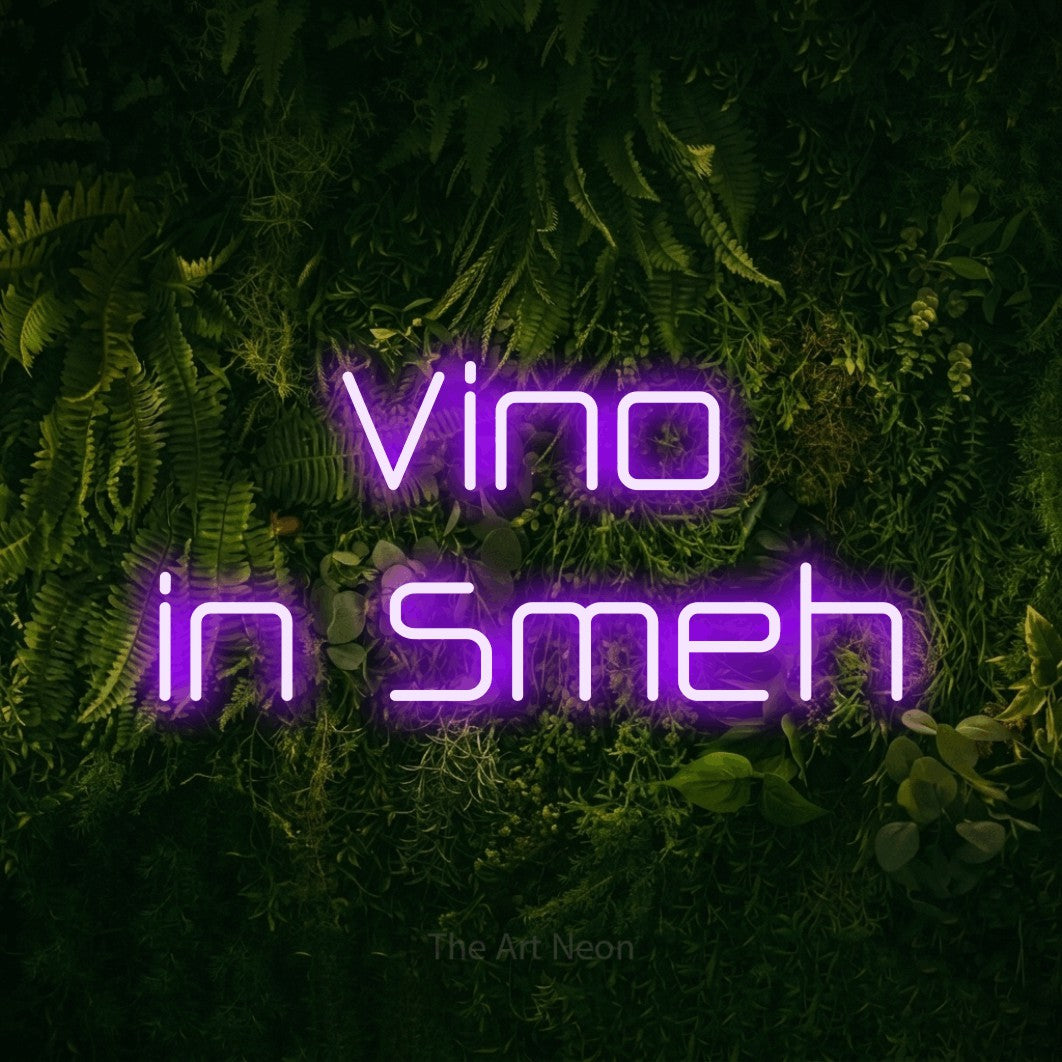 LED neon sign reading “Vino in Smeh”, arranged in two lines.
