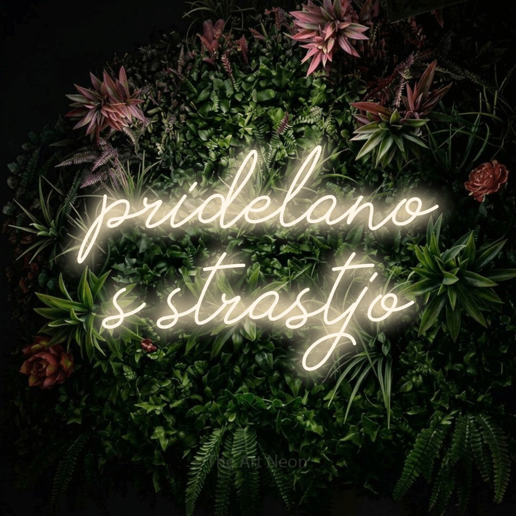 LED neon sign reading “pridelano s strastjo”, arranged in two lines.