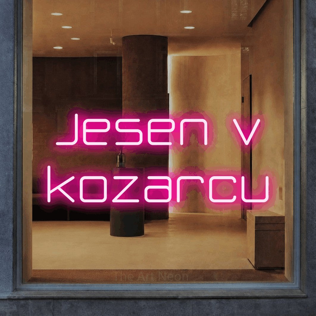 LED neon sign reading “Jesen v kozarcu”, arranged in two lines.