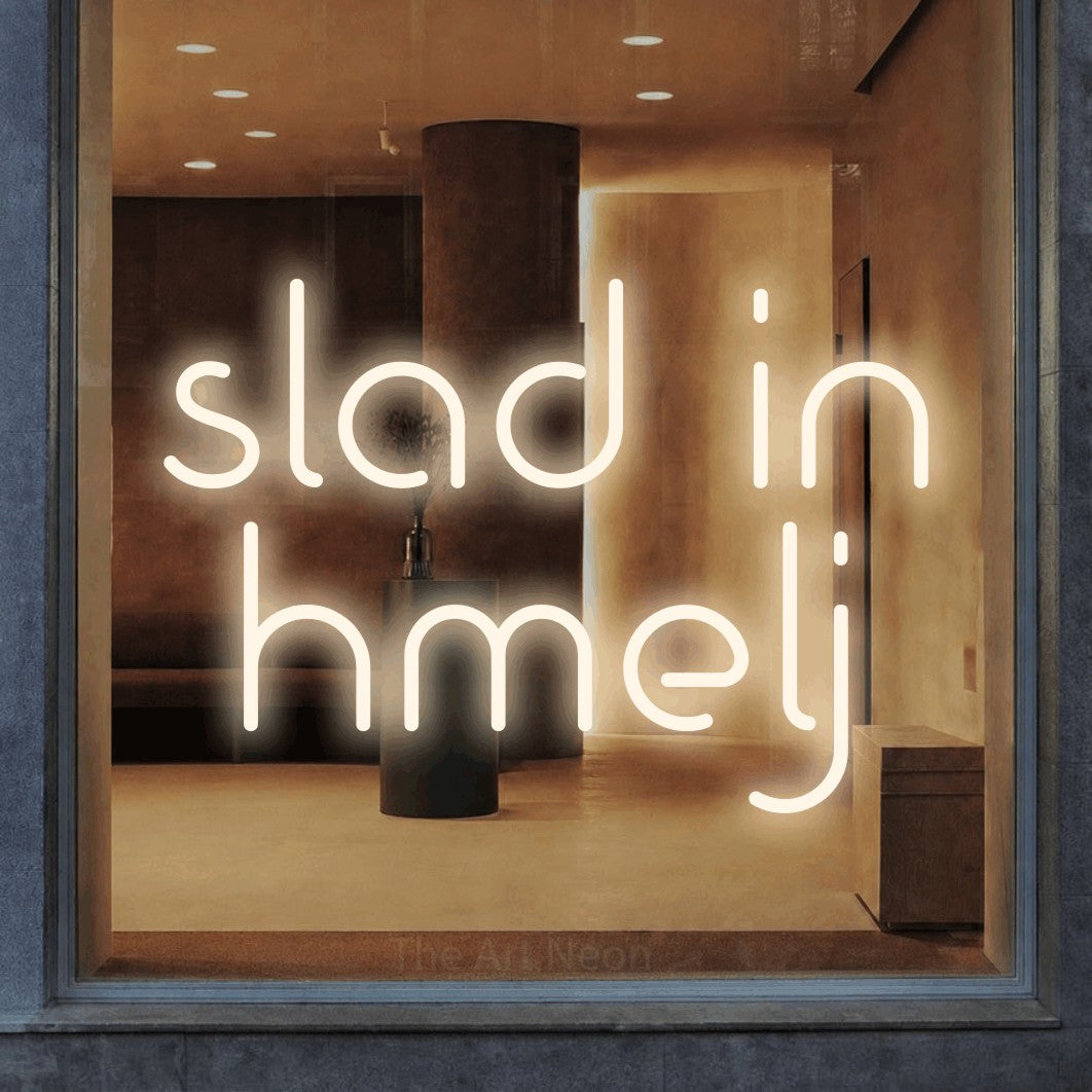 LED neon sign reading “slad in hmelj”, arranged in two lines.