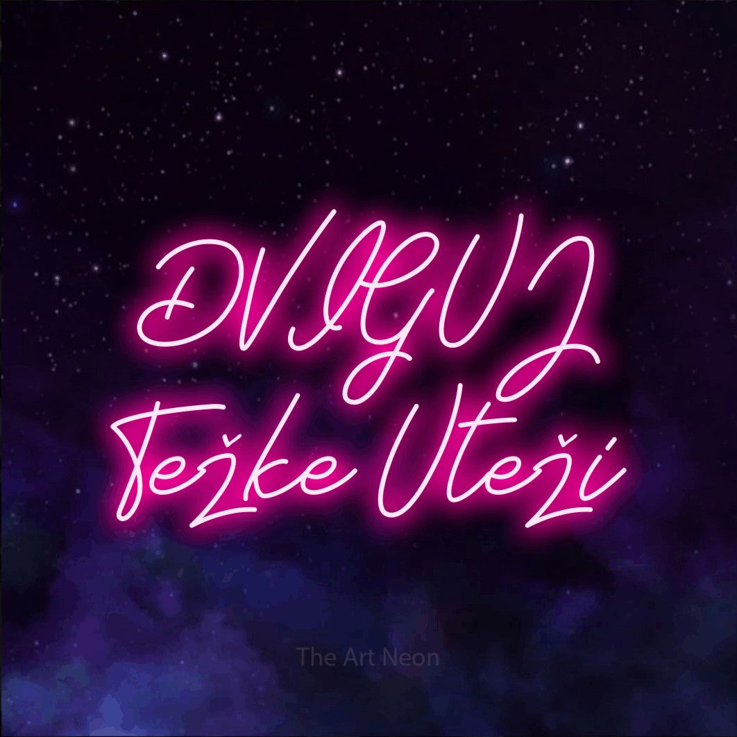 LED neon sign reading “DVIGUJ Težke Uteži”, arranged in two lines.