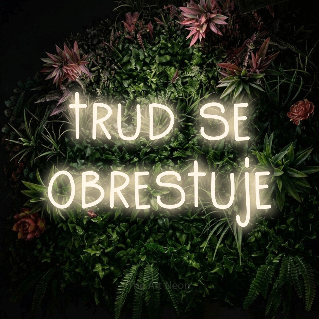 LED neon sign reading “trud se obrestuje”, arranged in two lines.
