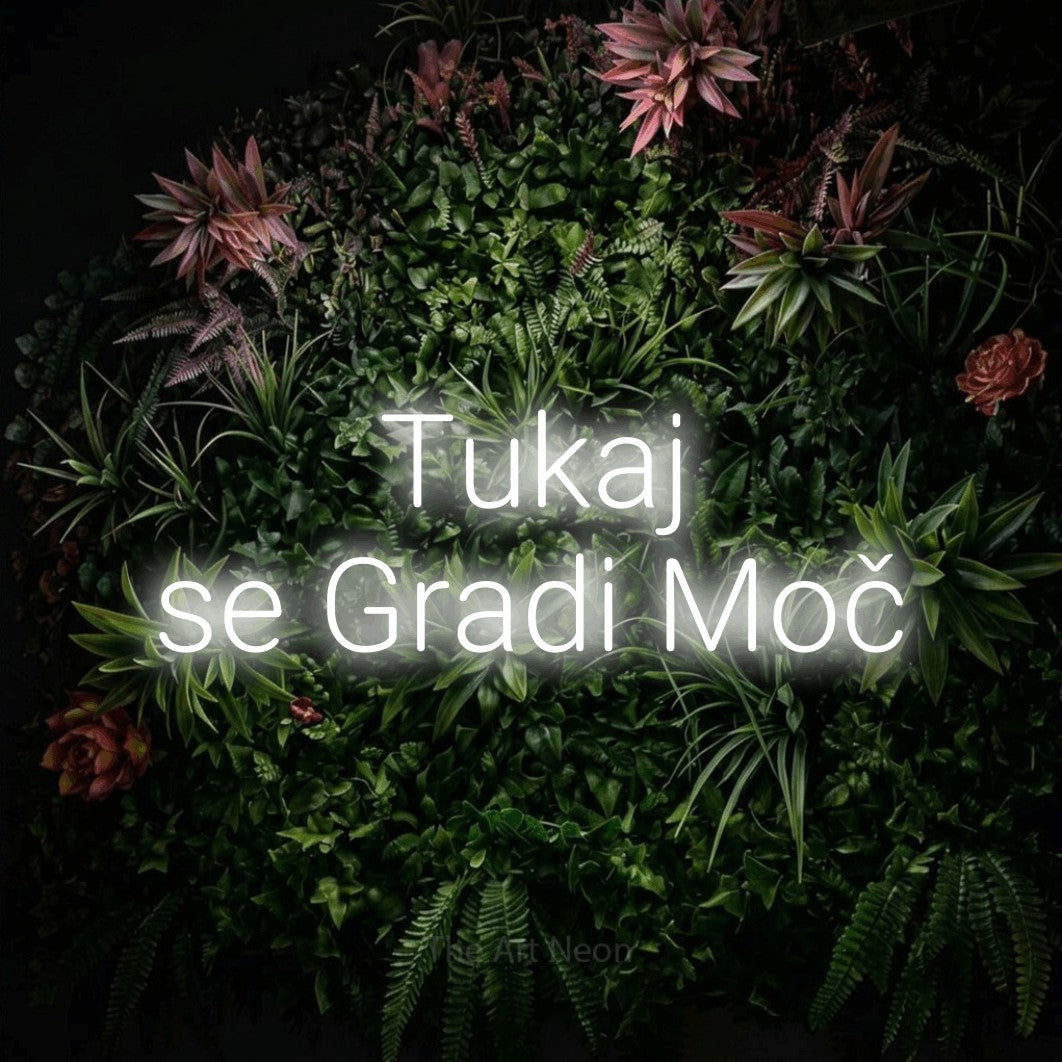 LED neon sign reading “Tukaj se Gradi Moč”, arranged in two lines.