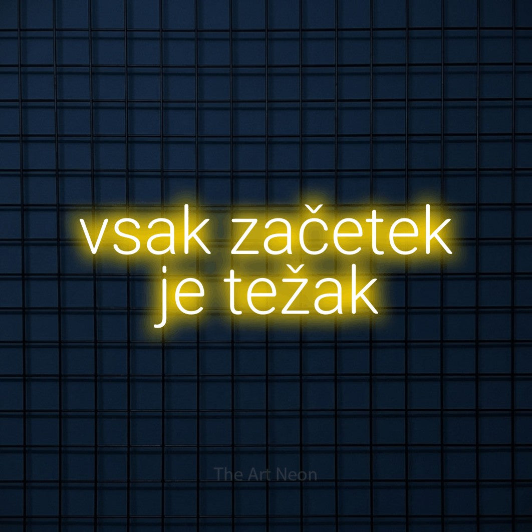 LED neon sign reading “vsak začetek je težak”, arranged in two lines.