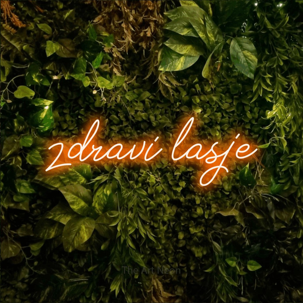 LED neon sign reading “zdravi lasje”, arranged in a single line.