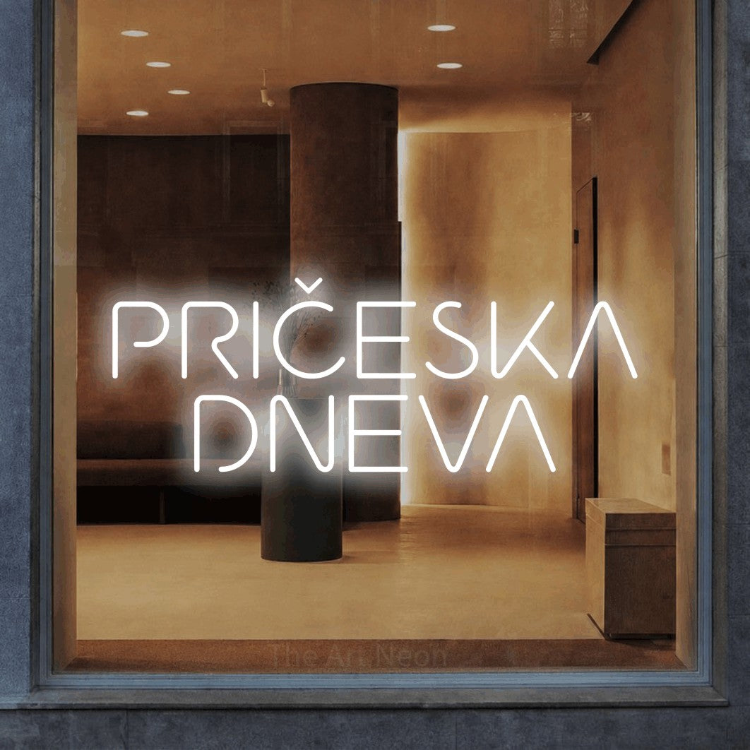 LED neon sign reading “PRIČESKA DNEVA”, arranged in two lines.