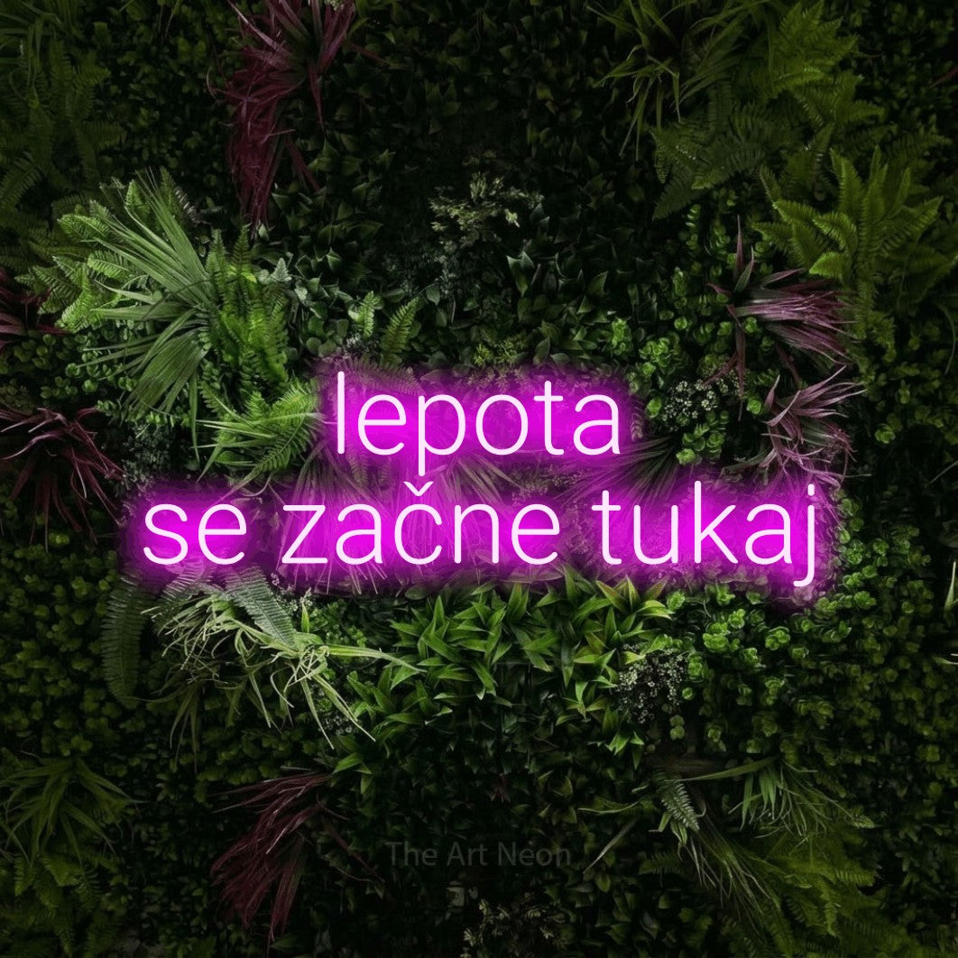 LED neon sign reading “lepota se začne tukaj”, arranged in two lines.