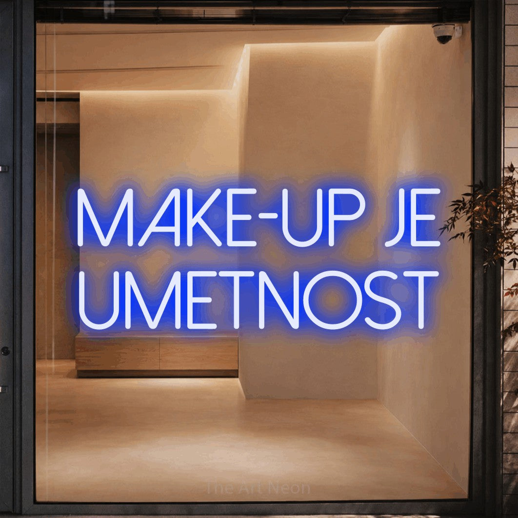 LED neon sign reading “Make-up je Umetnost”, arranged in two lines.