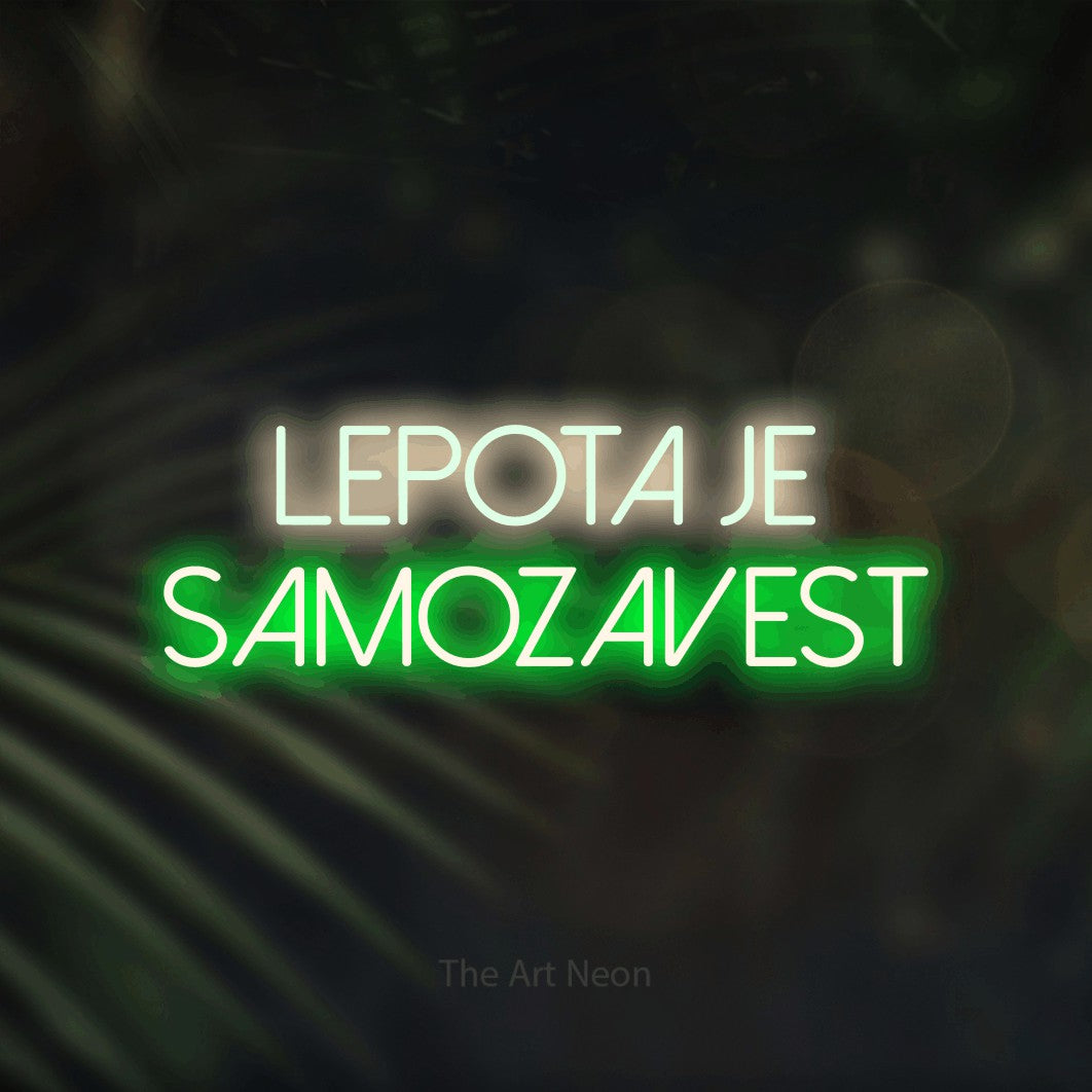 LED neon sign reading “lepota je samozavest”, arranged in two lines.