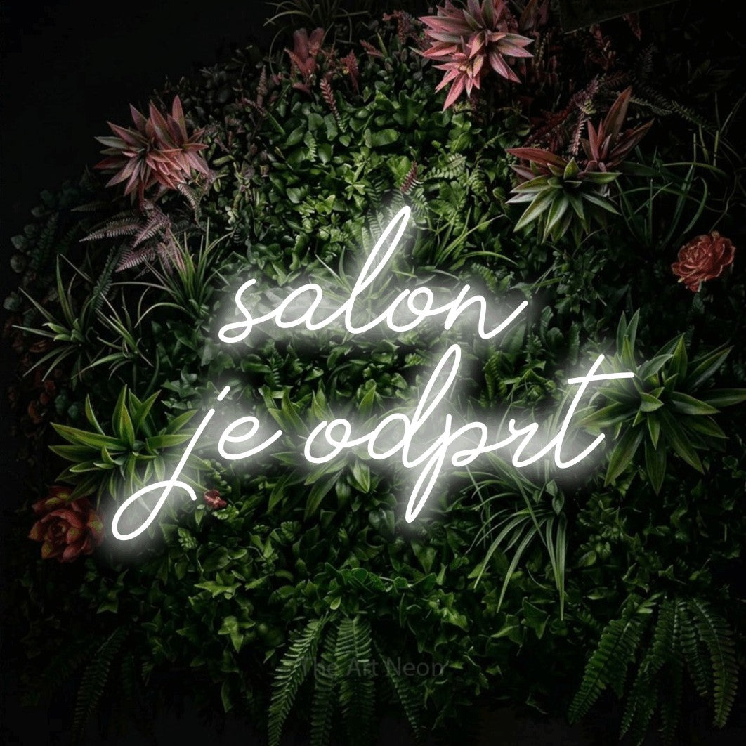 LED neon sign reading “salon je odprt”, arranged in two lines.