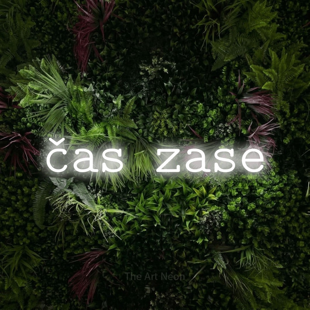 LED neon sign reading “čas zase”, arranged in a single line.