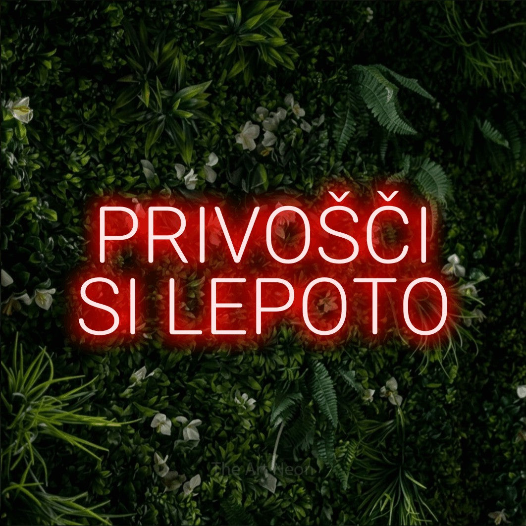 LED neon sign reading “PRIVOŠČI SI LEPOTO”, arranged in two lines.
