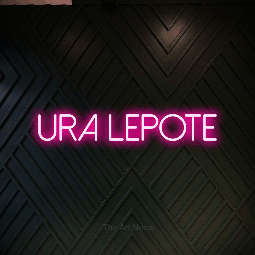 LED neon sign reading “ura lepote”, arranged in a single line.