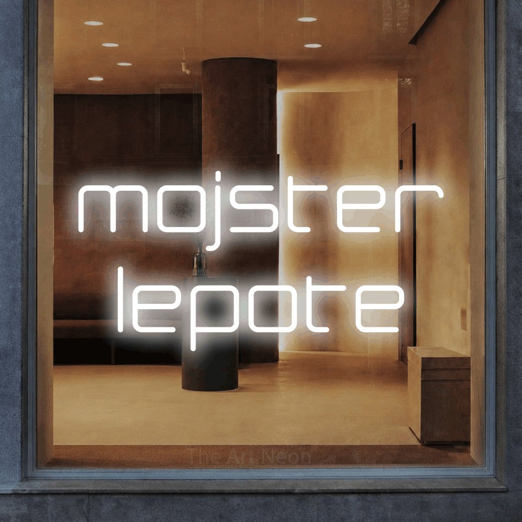 LED neon sign reading “mojster lepote”, arranged in two lines.