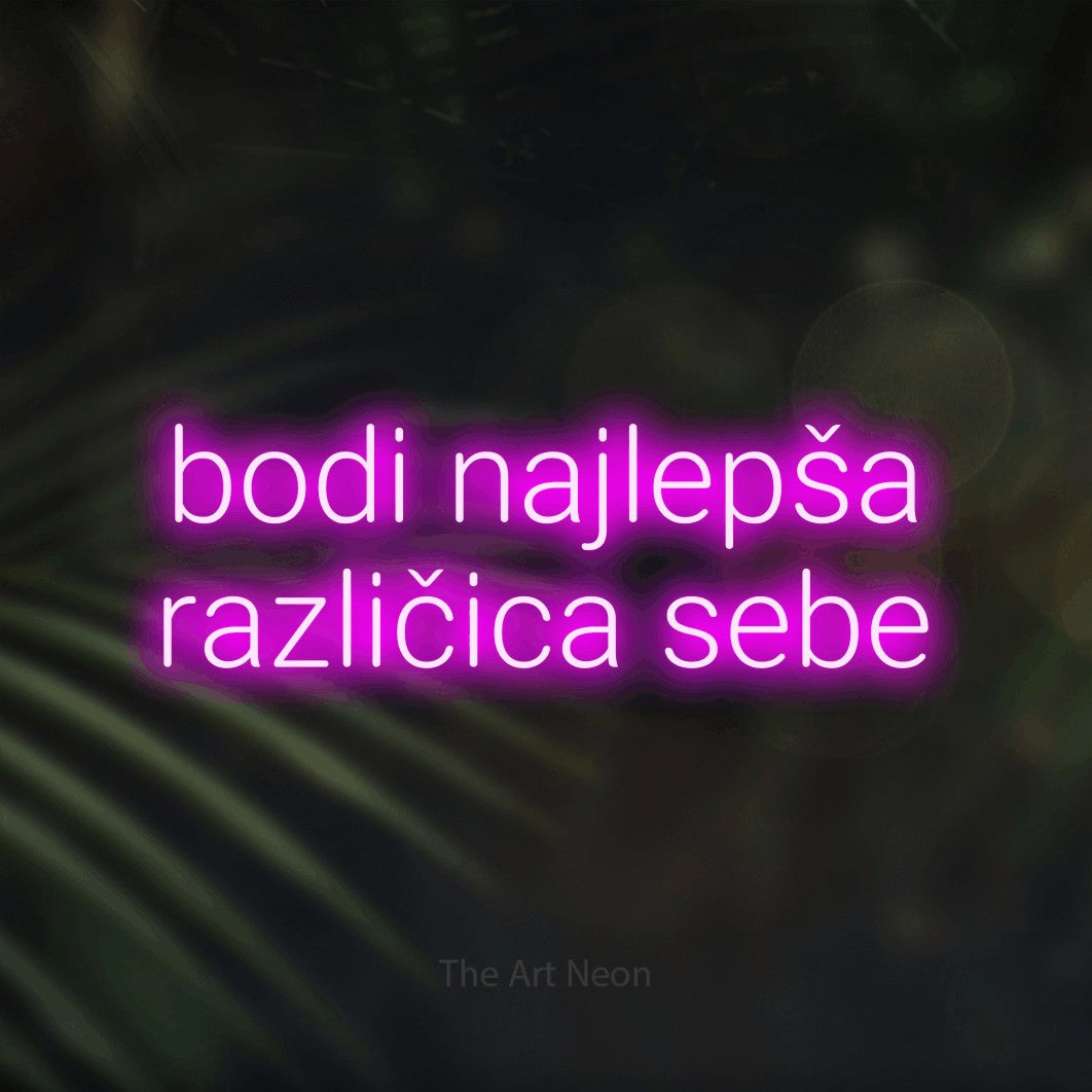LED neon sign reading “bodi najlepša različica sebe”, arranged in two lines.