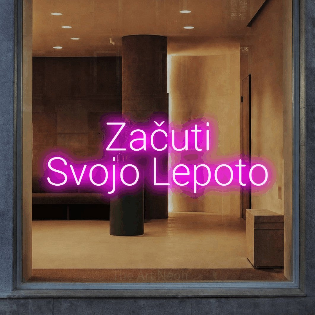 LED neon sign reading “Začuti Svojo Lepoto”, arranged in two lines.