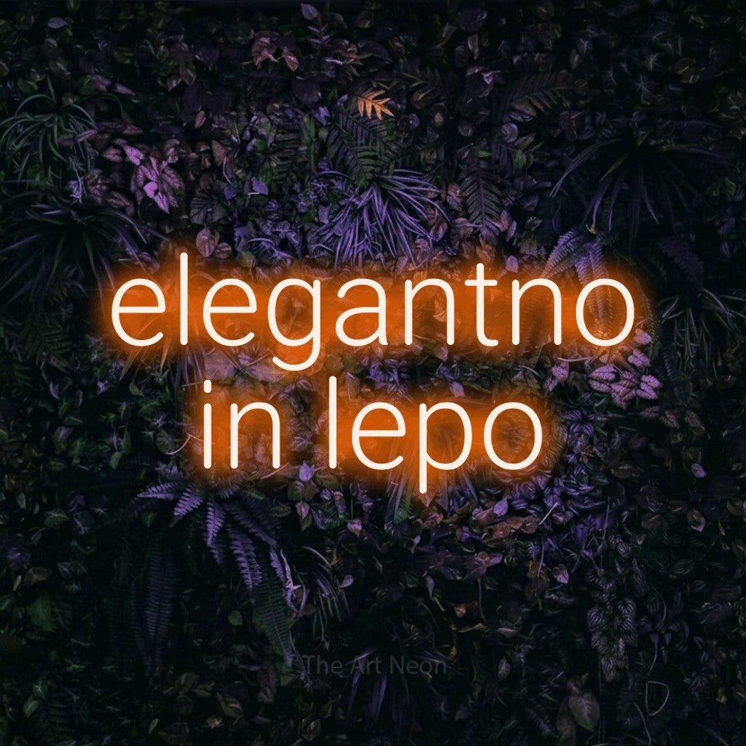 LED neon sign reading “elegantno in lepo”, arranged in two lines.