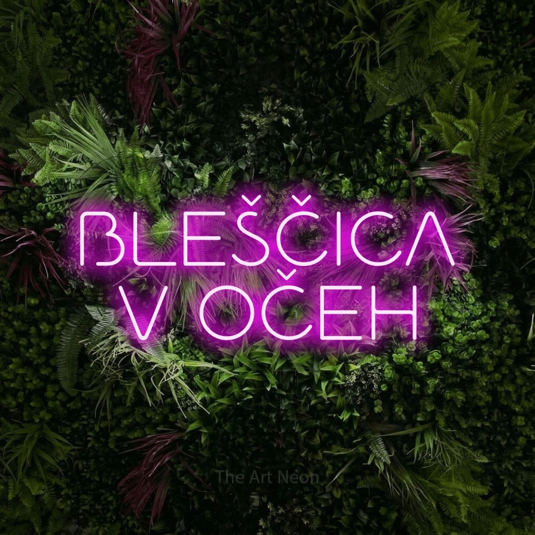 LED neon sign reading “BLEŠČICA V OČEH”, arranged in two lines.