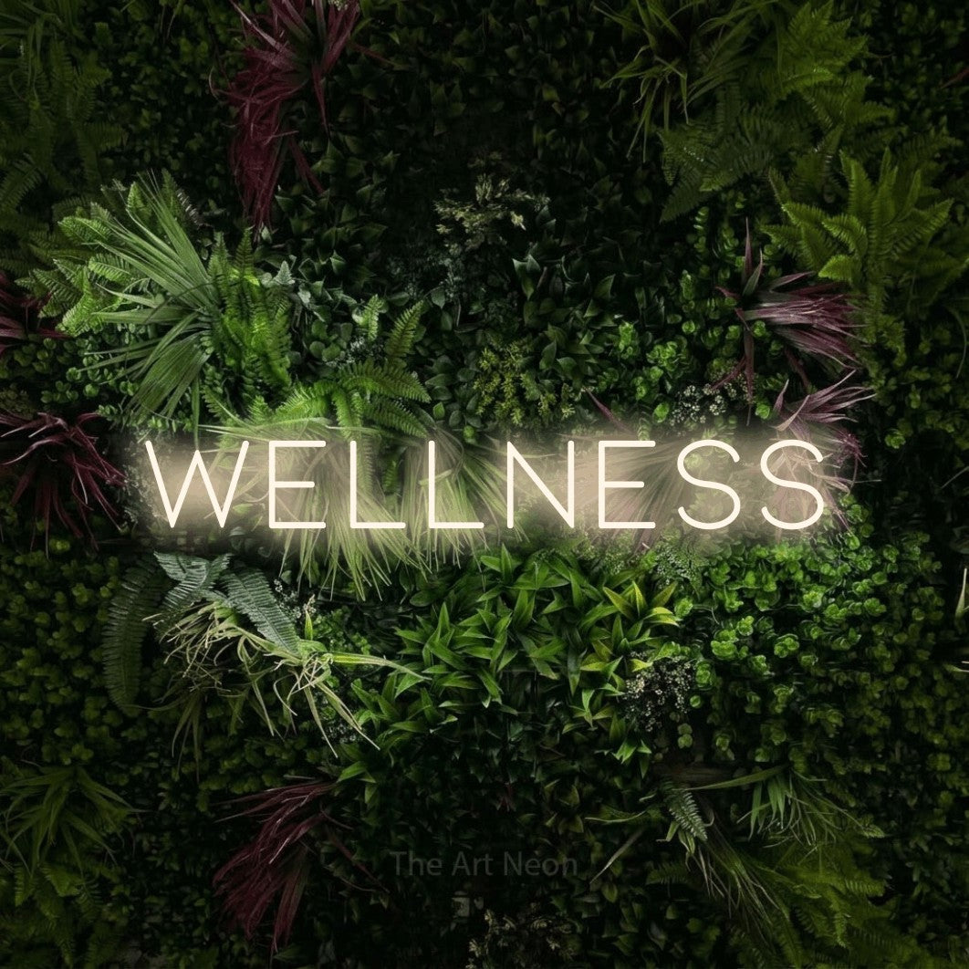 LED neon sign reading “Wellness”, arranged in a single line.