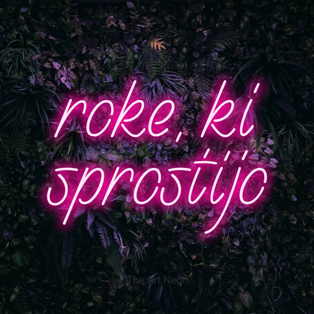 LED neon sign reading “roke, ki sprostijo”, arranged in two lines.