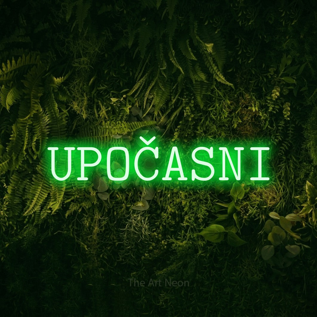 LED neon sign reading “UPOČASNI”, arranged in a single line.