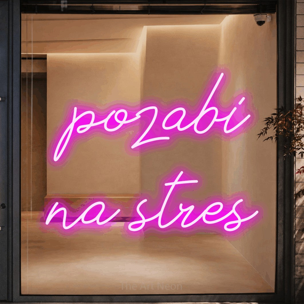 LED neon sign reading “pozabi na stres”, arranged in two lines.