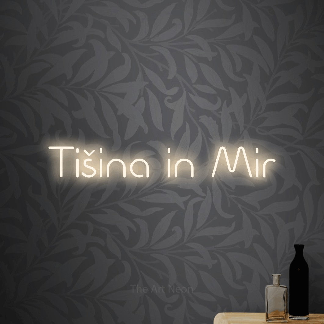 LED neon sign reading “Tišina in Mir”, arranged in a single line.