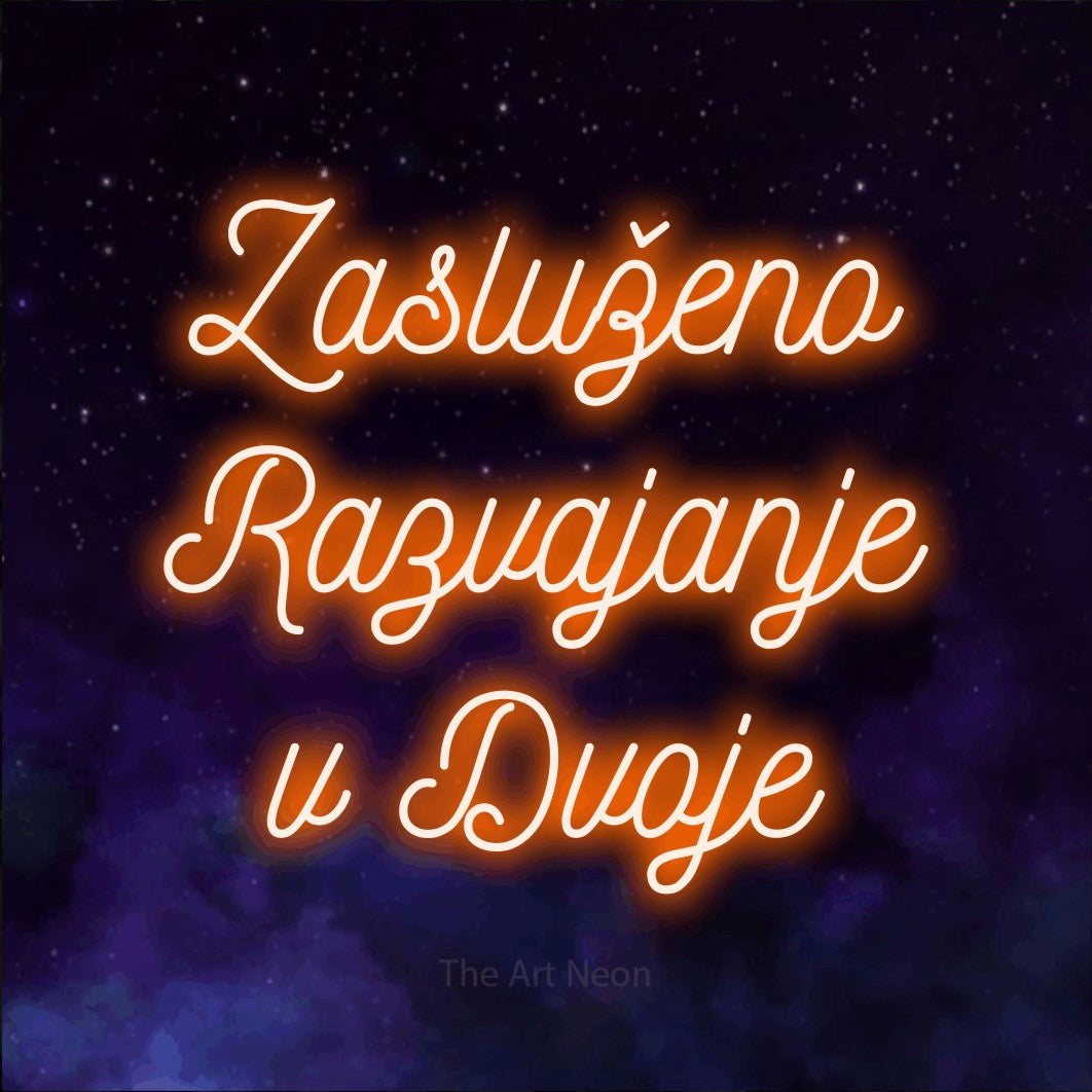 LED neon sign reading “Zasluženo Razvajanje v Dvoje”, arranged in three lines.