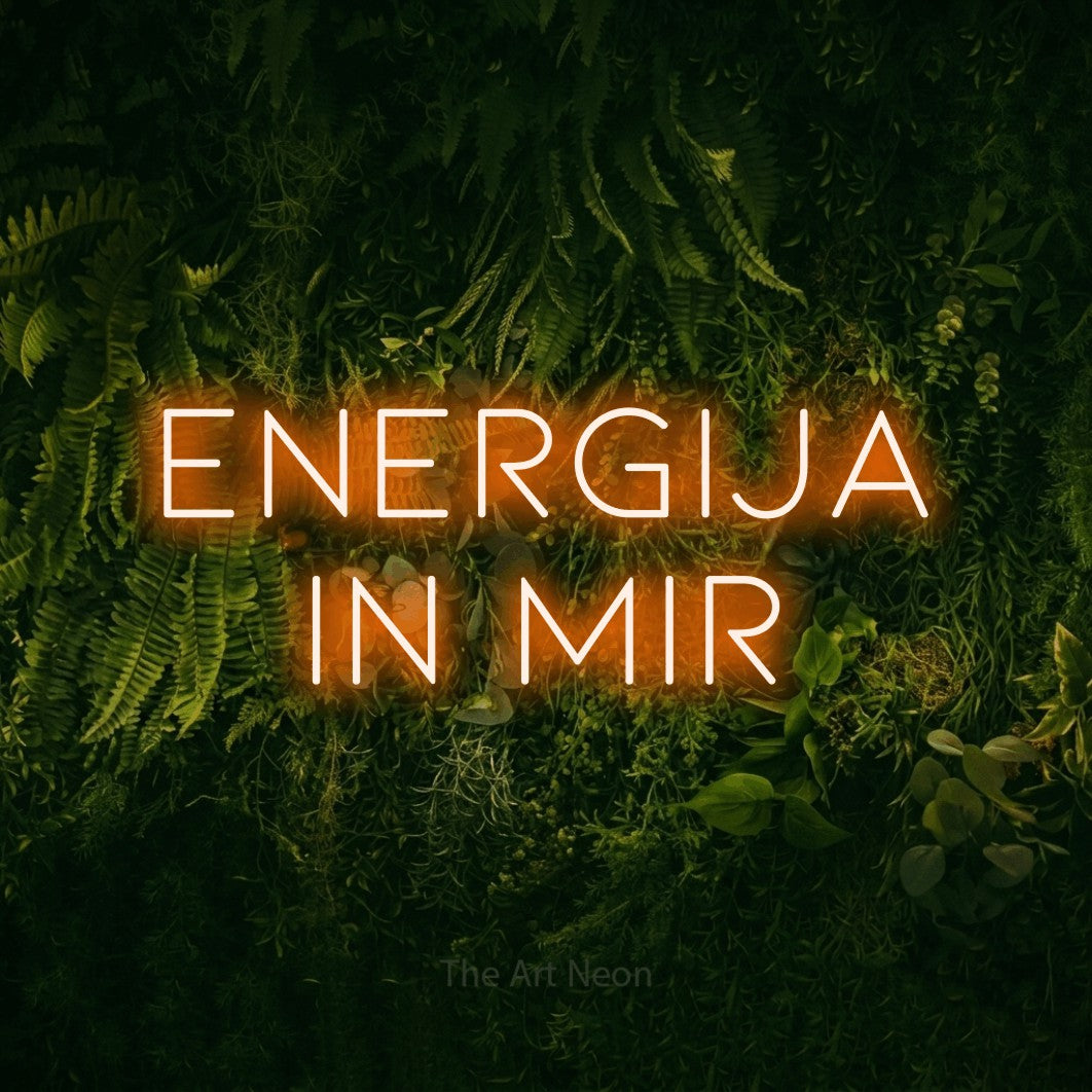 LED neon sign reading “energija in mir”, arranged in two lines.
