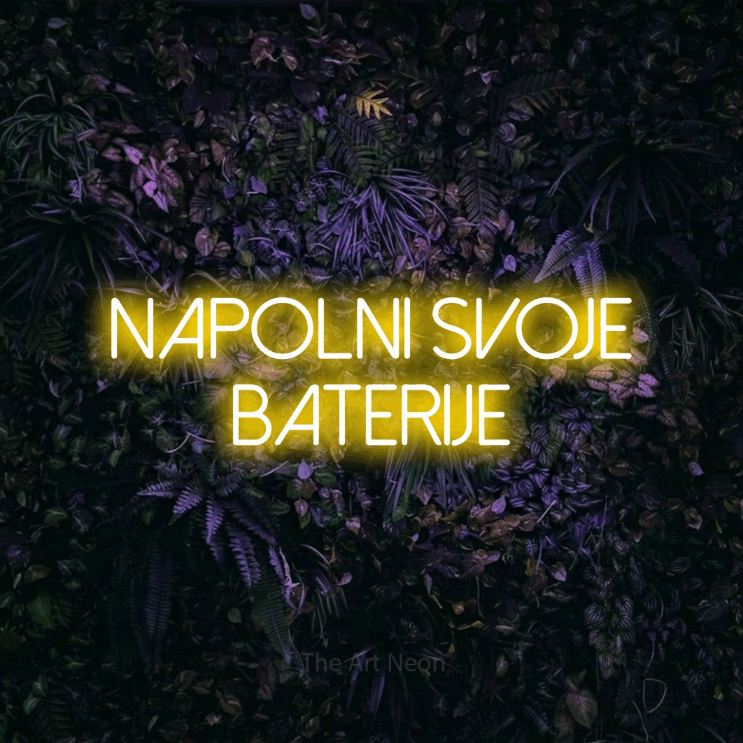 LED neon sign reading “Napolni Svoje Baterije”, arranged in two lines.