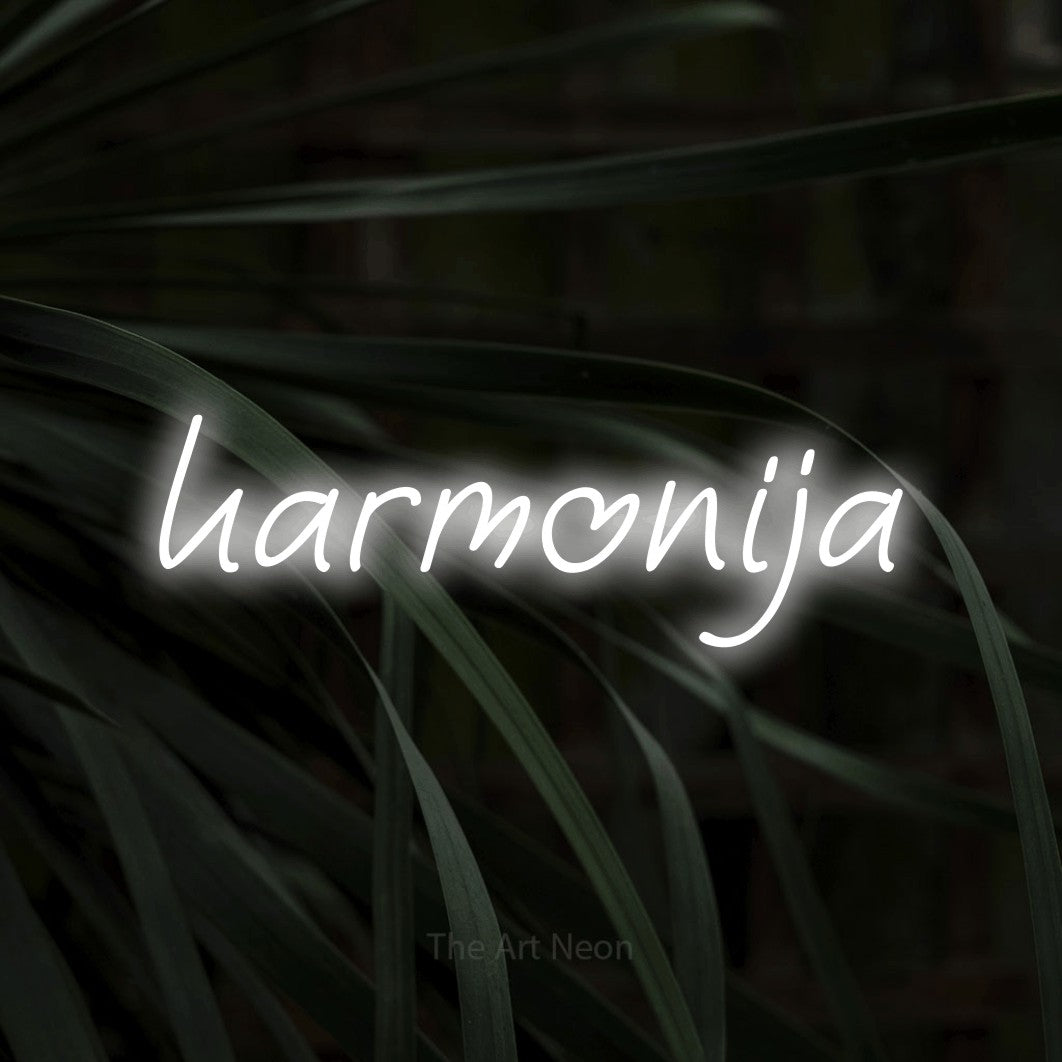 LED neon sign reading “harmonija”, arranged in a single line.