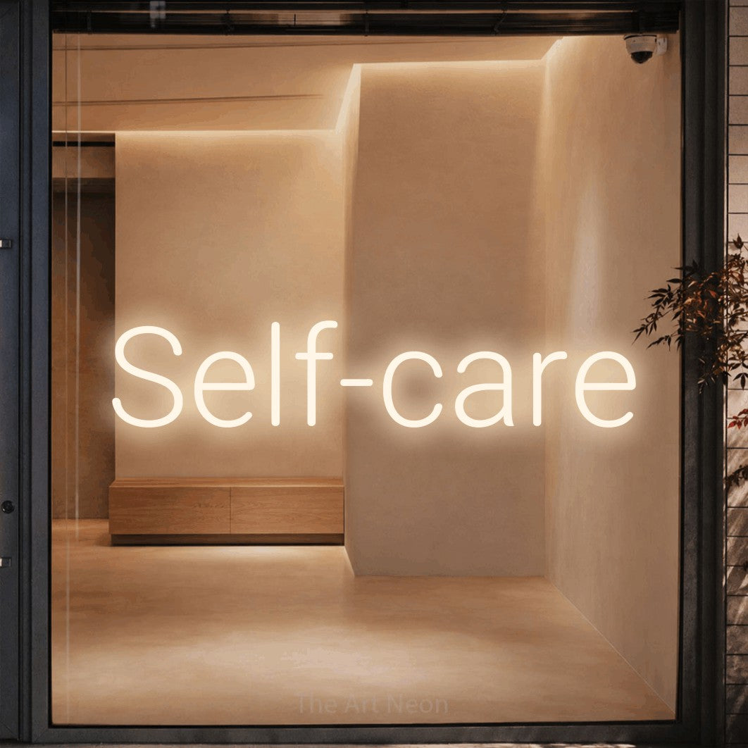 LED neon sign reading “Self-care”, arranged in a single line.