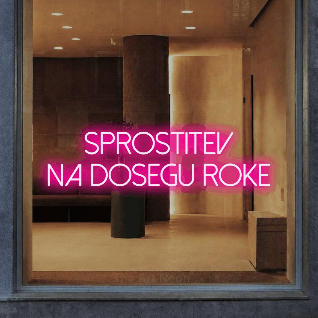 LED neon sign reading “Sprostitev na Dosegu Roke”, arranged in two lines.