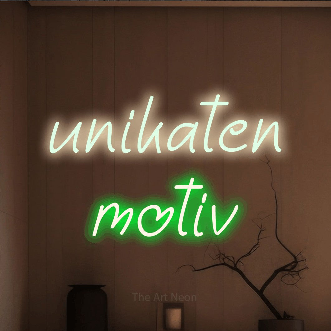 LED neon sign reading “unikaten motiv”, arranged in two lines.