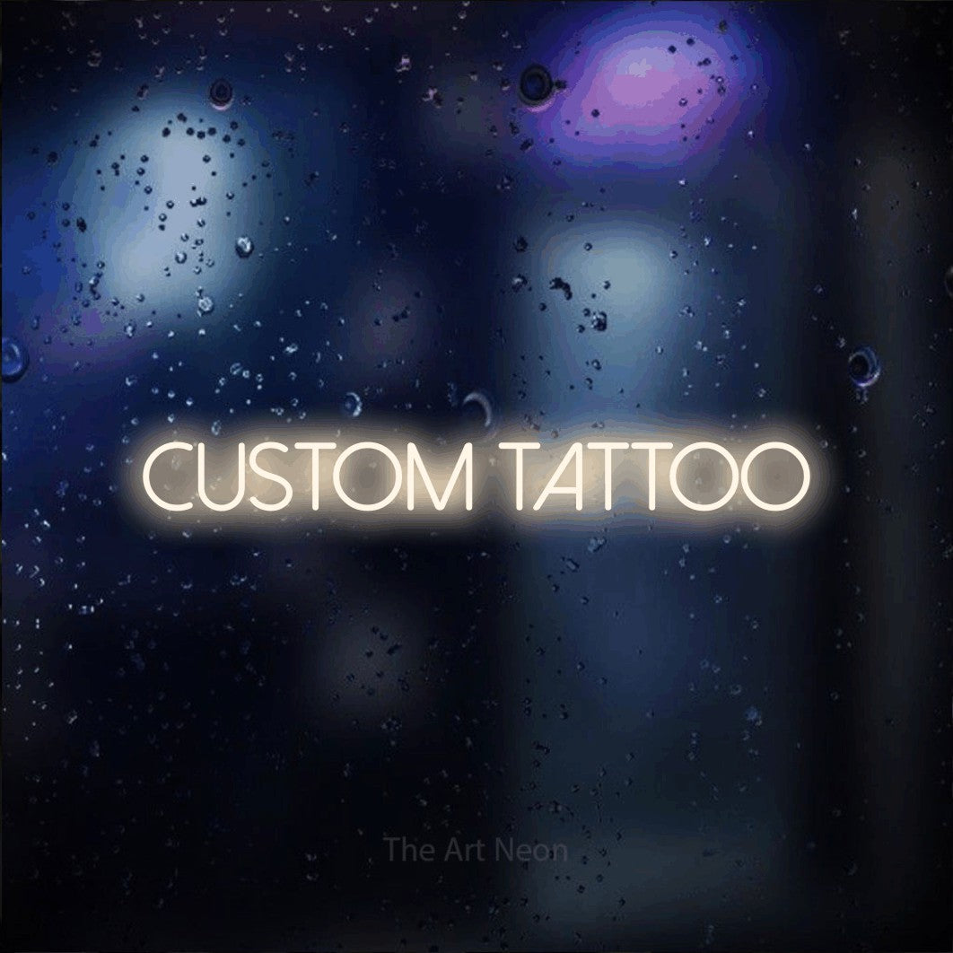 LED neon sign reading “CUSTOM TATTOO”, arranged in a single line.
