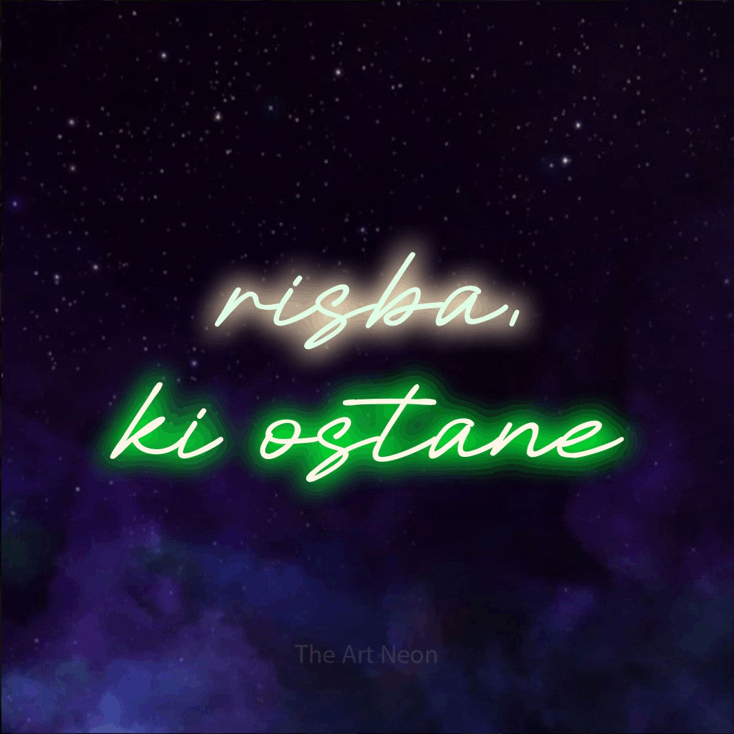 LED neon sign reading “risba, ki ostane”, arranged in two lines.