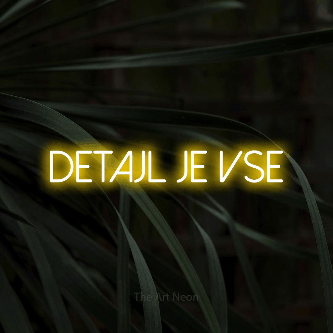 LED neon sign reading “DETAJL JE VSE”, arranged in a single line.